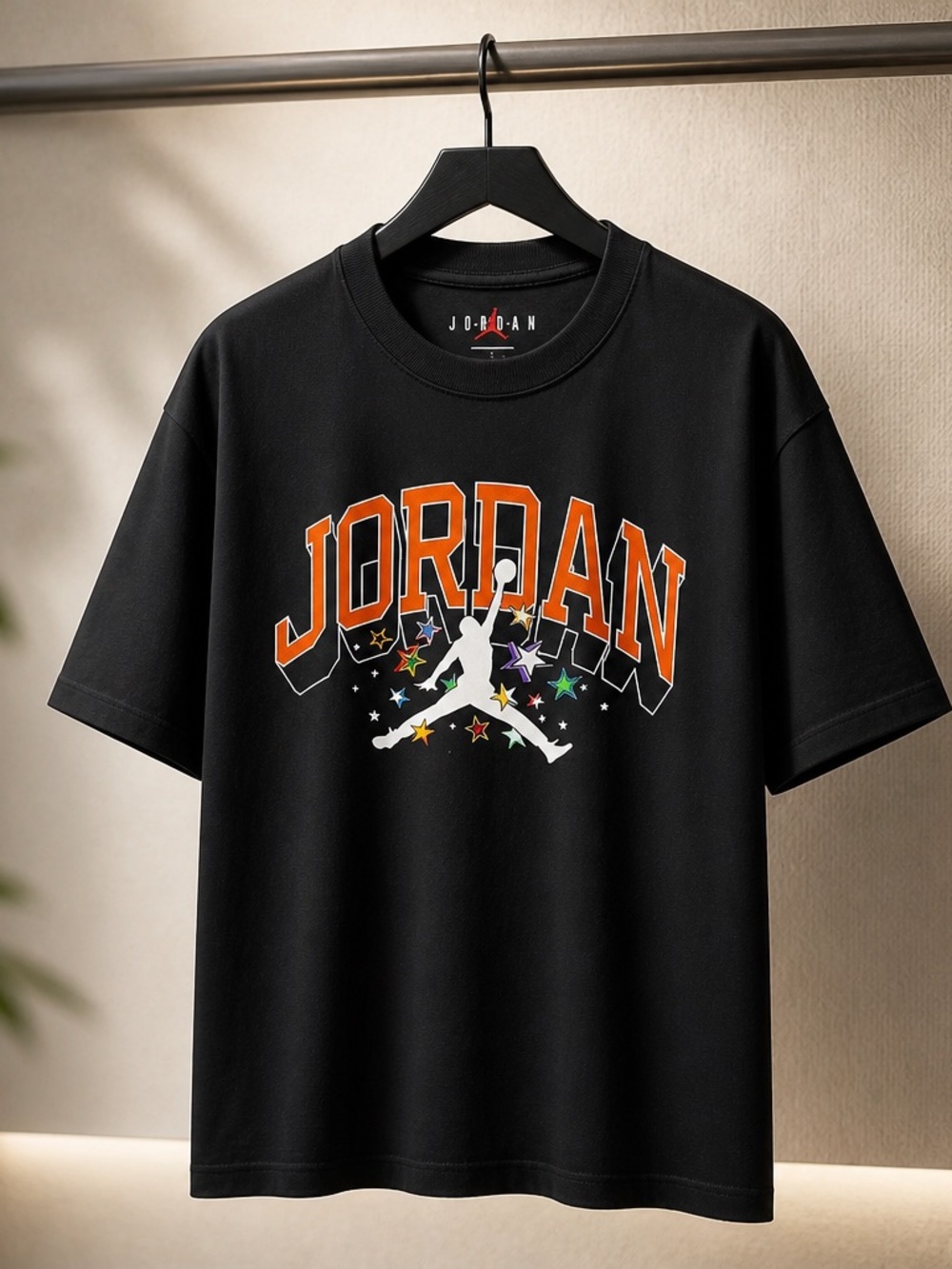 Jordan Black Graphic Tee with Orange Lettering and Multicolor Stars